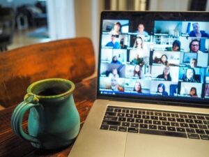 Mug next to a laptop displaying a video conference session