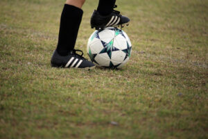 Soccer player's feet trapping a ball